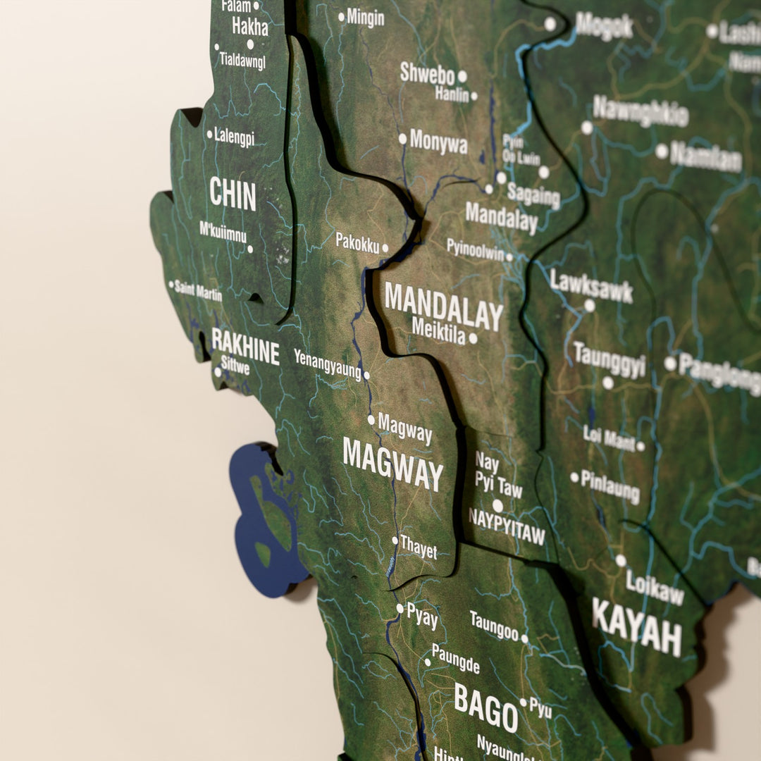 Close-up of the Satellite Myanmar wooden wall map with layered regions and printed names