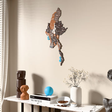 Soil Myanmar wooden wall map beside a sheer curtain, angled view