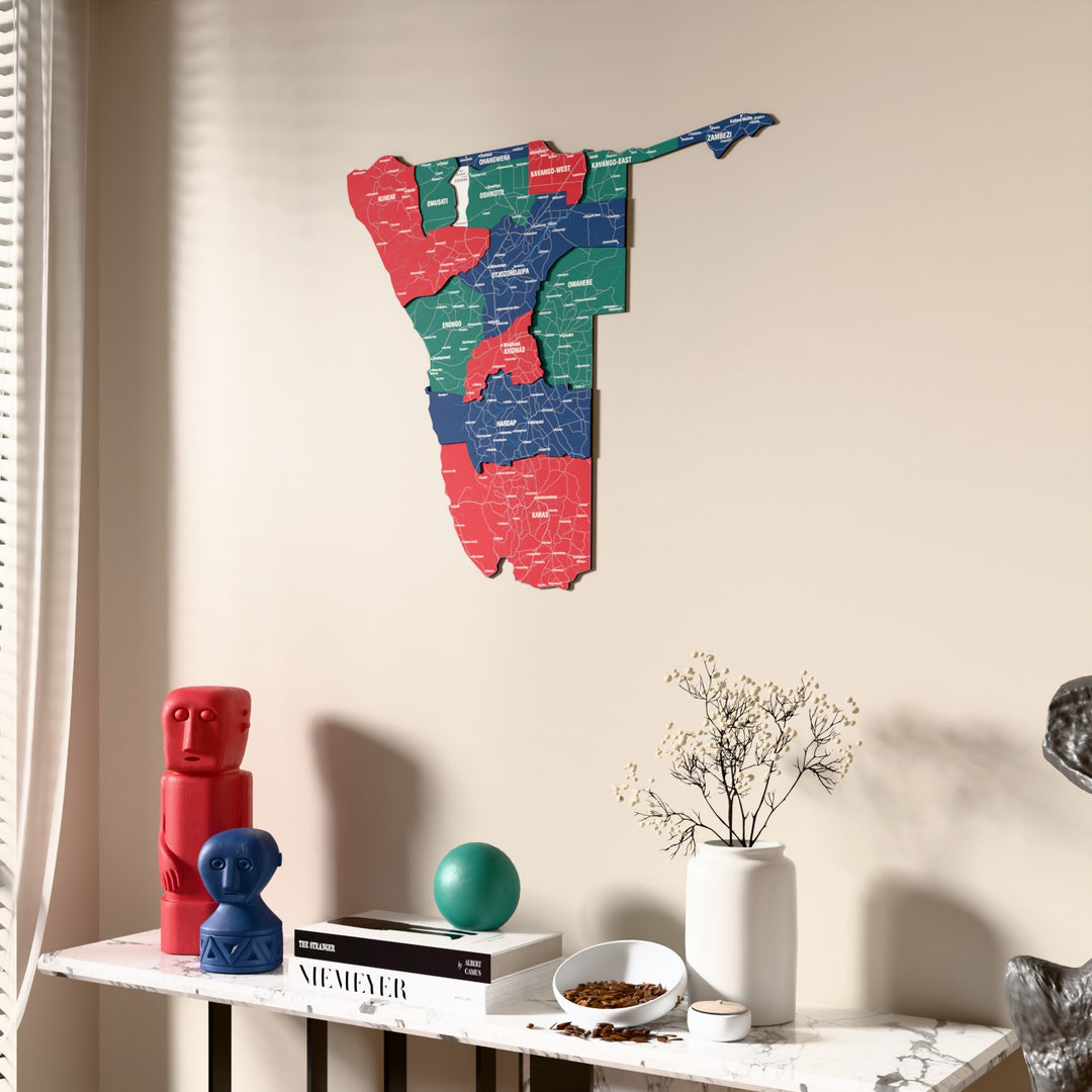 Flag colored Namibia wooden wall map beside a sheer curtain, angled view