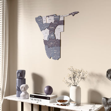 Nimbus Namibia wooden wall map beside a sheer curtain, angled view