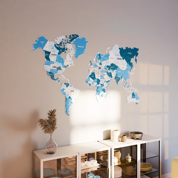 Navy metal world map on a warm wall above a white glass cabinet in soft window light