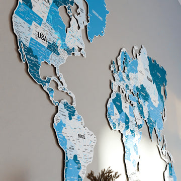 Side-angle view of the Americas and Eurasia on the Navy metal world map, with USA and Brazil labels