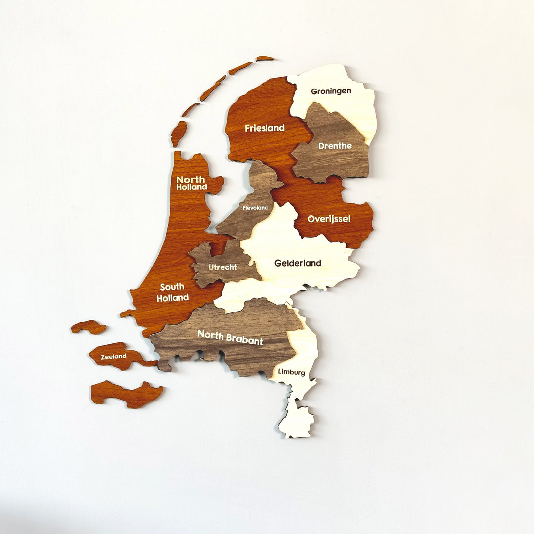 3D wooden Netherlands map with province names in orange-brown, taupe and cream, with the Zeeland islands as separate pieces