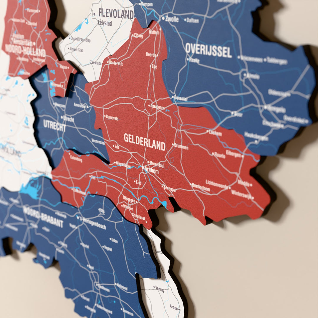 Close-up of the Flag colored Netherlands wooden wall map with layered regions and printed names