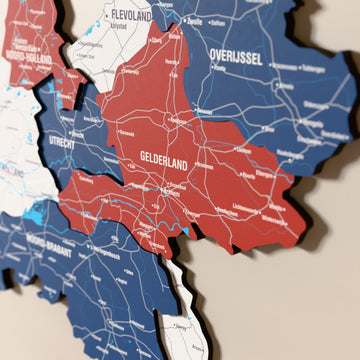 Close-up of the Flag colored Netherlands wooden wall map with layered regions and printed names