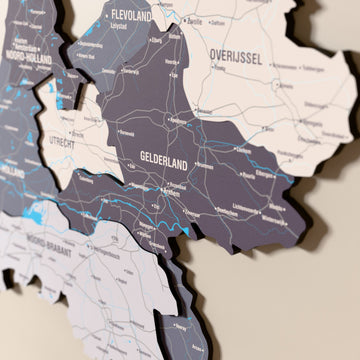 Close-up of the Nimbus Netherlands wooden wall map with layered regions and printed names