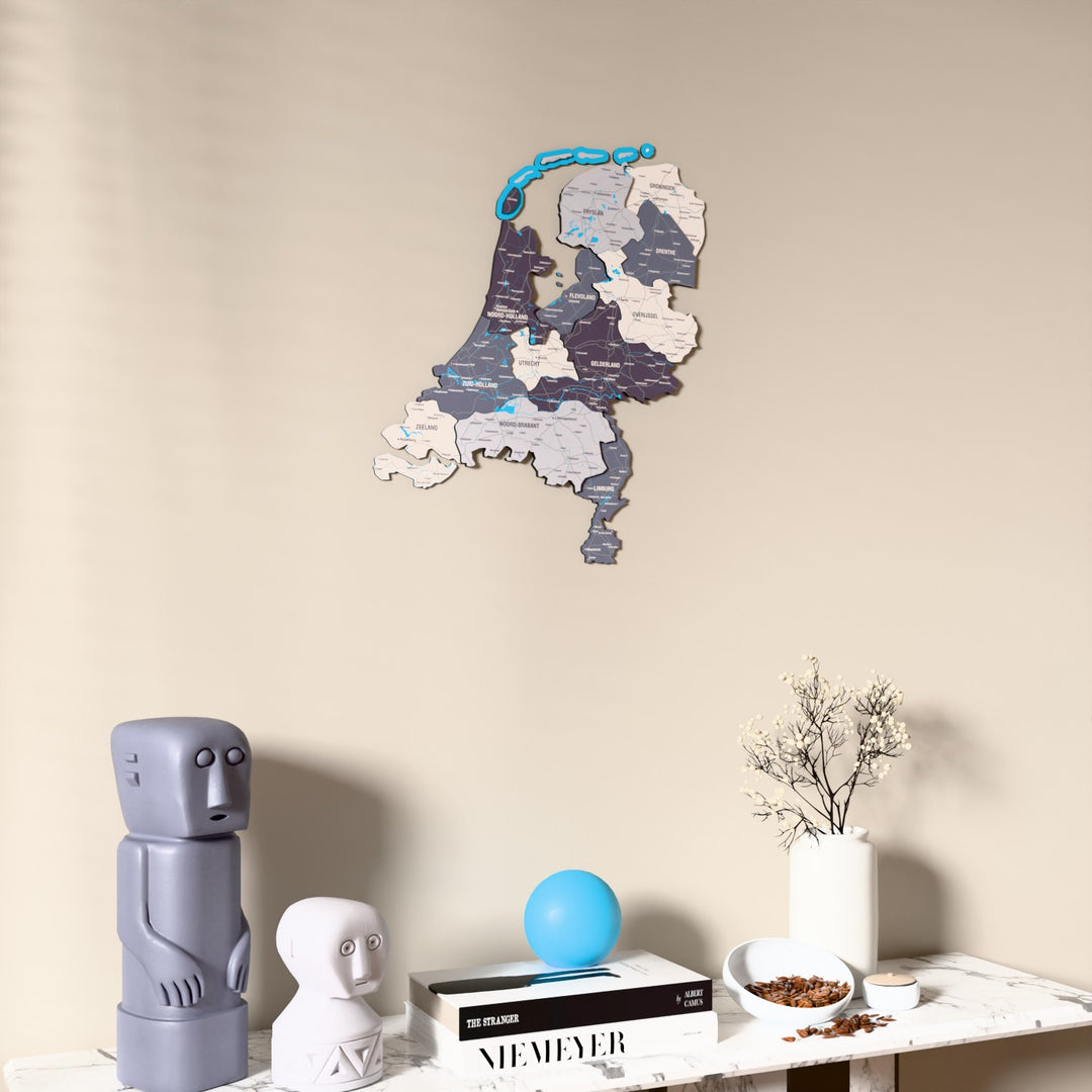 Nimbus Netherlands wooden wall map on a beige wall above a console with figurines