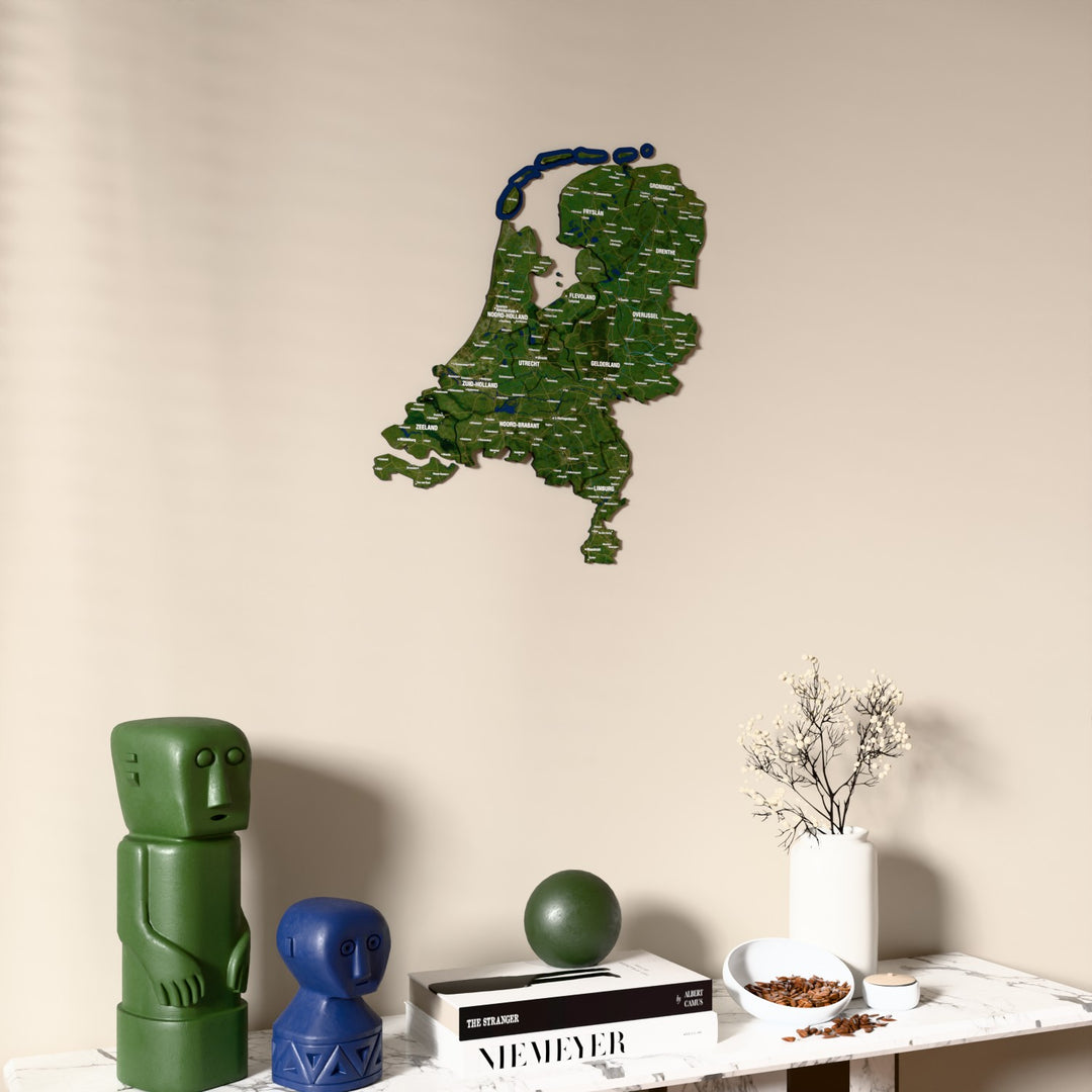 Satellite Netherlands wooden wall map on a beige wall above a console with figurines