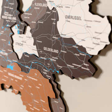 Close-up of the Soil Netherlands wooden wall map with layered regions and printed names