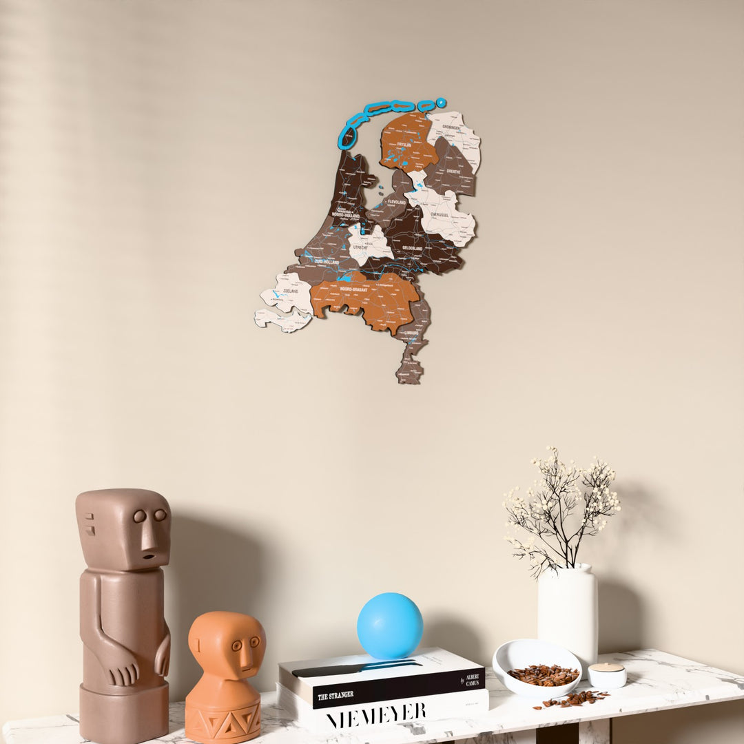 Soil Netherlands wooden wall map on a beige wall above a console with figurines