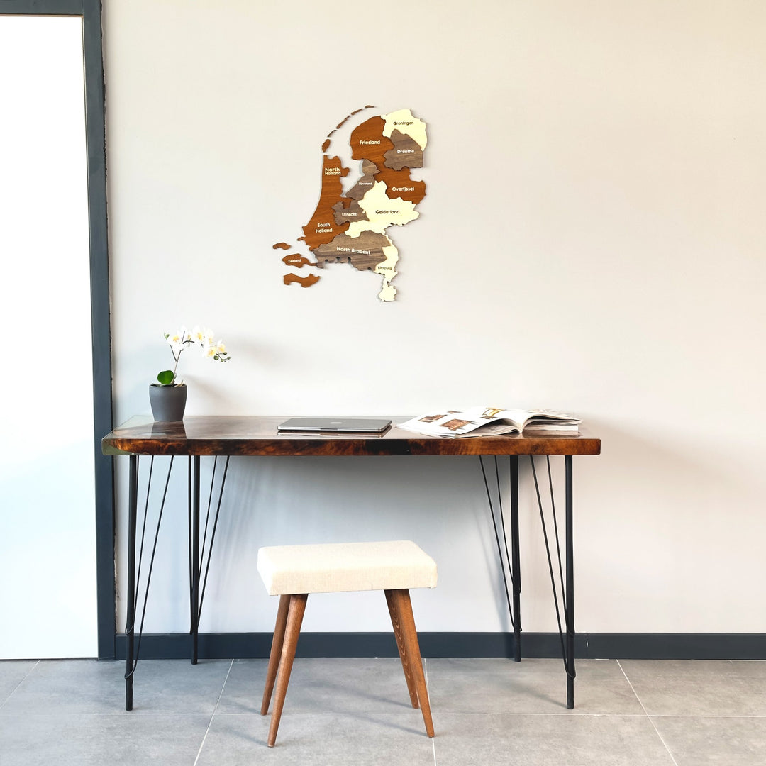 Netherlands wooden wall map above a live-edge desk, wide view