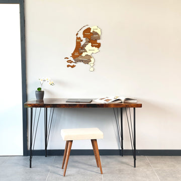 Netherlands wooden wall map above a live-edge desk, wide view