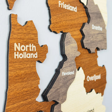 Angled close-up of the wooden Netherlands map showing North Holland, Friesland, Drenthe, Flevoland and Overijssel