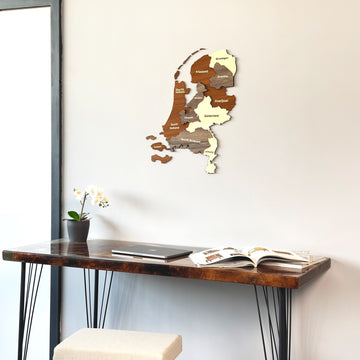 Netherlands wooden wall map close view above a resin-topped desk