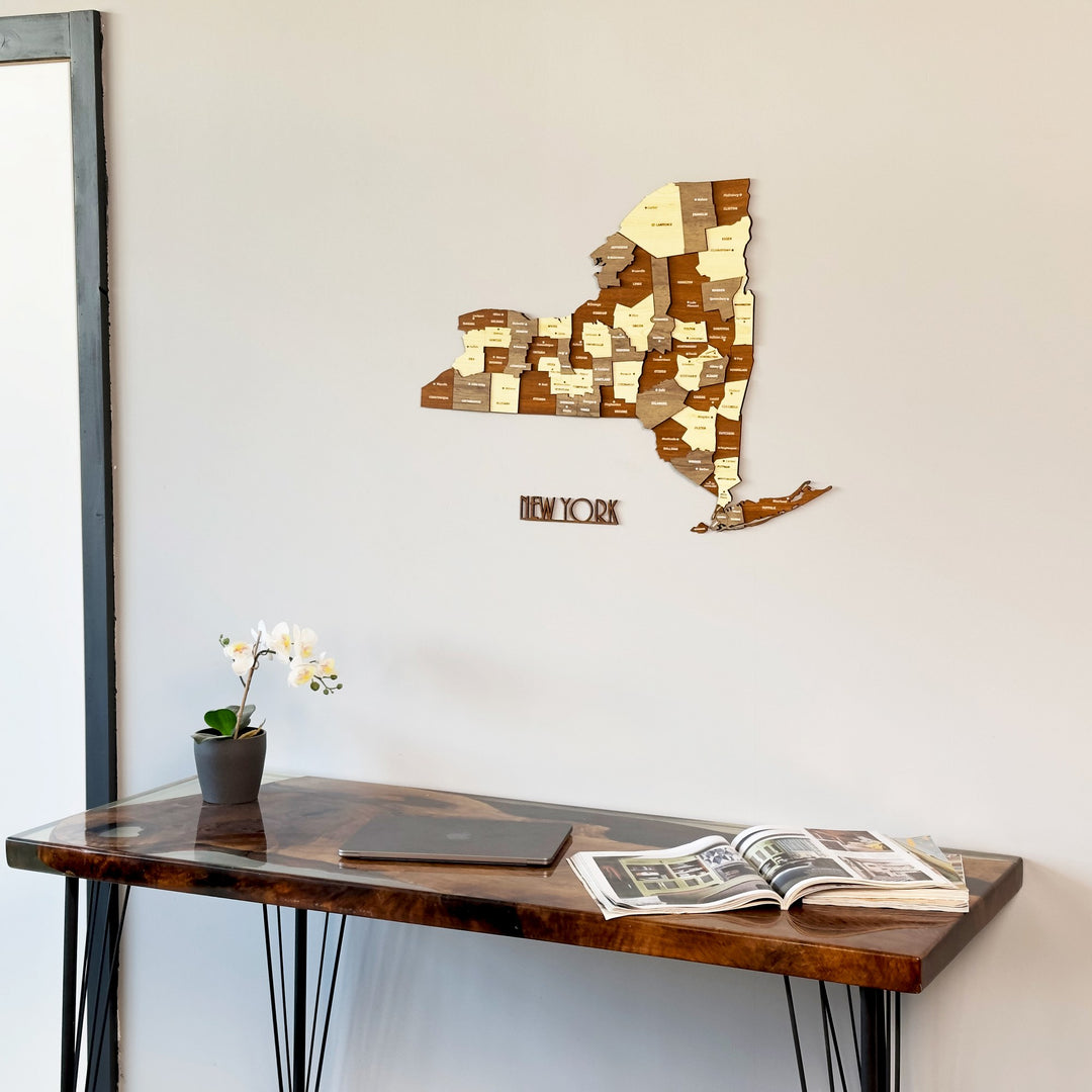 New York wooden wall map on a gray wall above a dark desk