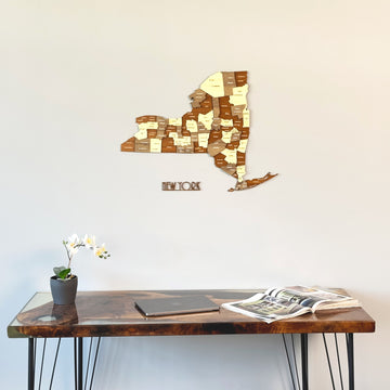 New York wooden wall map with cut-out name, close view above a resin-topped desk