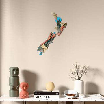 Sage New Zealand wooden wall map above a marble console, front view