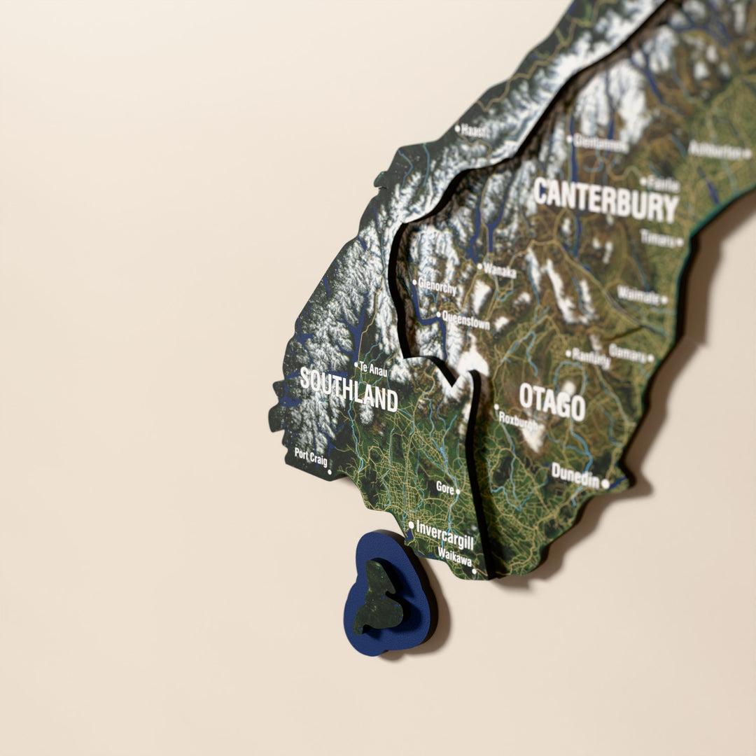 Close-up of the Satellite New Zealand wooden wall map with layered regions and printed names