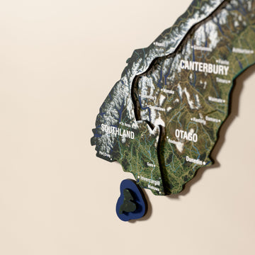 Close-up of the Satellite New Zealand wooden wall map with layered regions and printed names