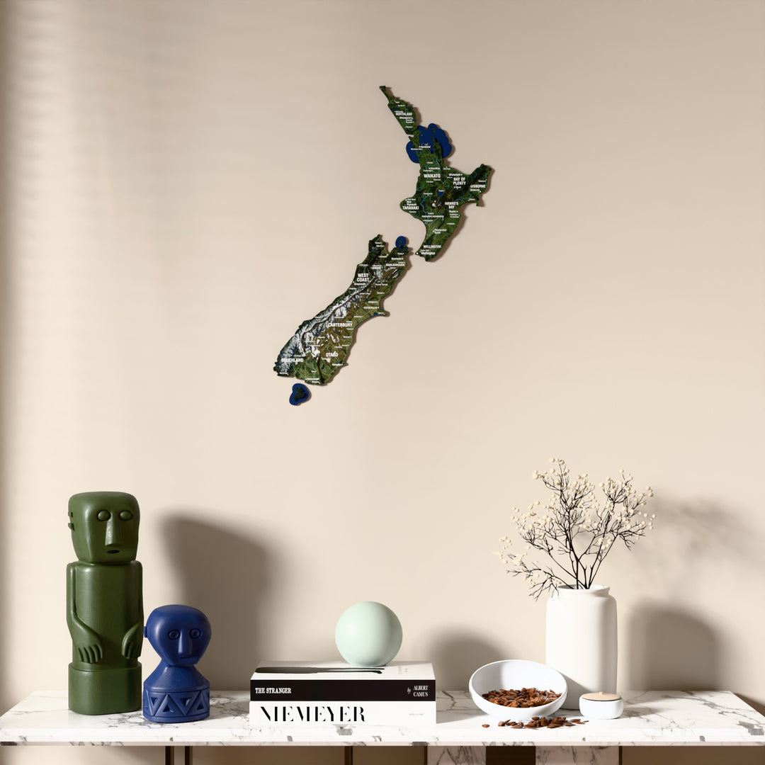 Satellite New Zealand wooden wall map above a marble console, front view