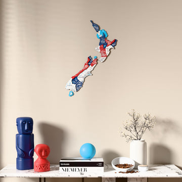 Flag colored New Zealand wooden wall map above a marble console, front view