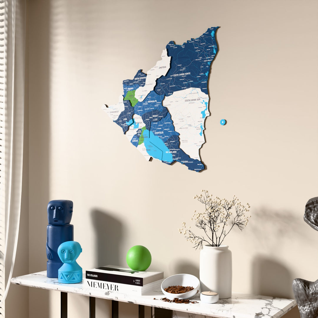 Flag colored Nicaragua wooden wall map beside a sheer curtain, angled view