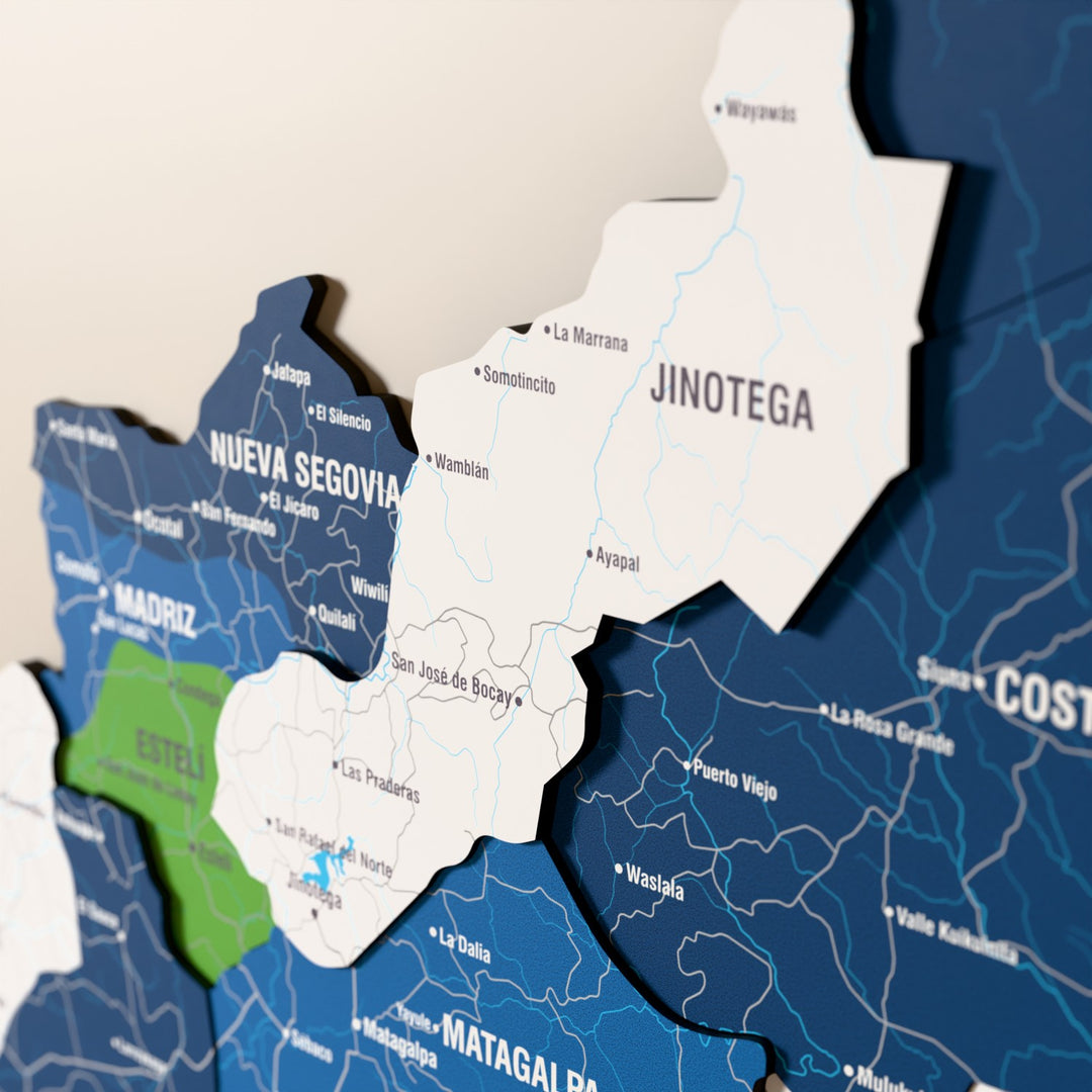 Close-up of the Flag colored Nicaragua wooden wall map with layered regions and printed names