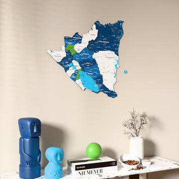 Flag colored Nicaragua wooden wall map on a beige wall above a console with figurines
