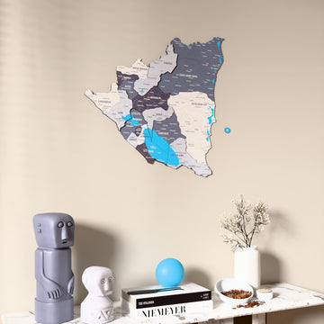 Nimbus Nicaragua wooden wall map on a beige wall above a console with figurines