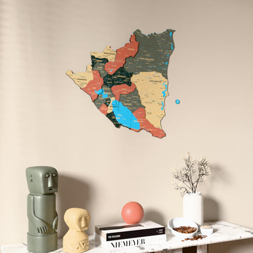 Sage Nicaragua wooden wall map on a beige wall above a console with figurines