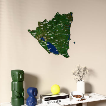 Satellite Nicaragua wooden wall map on a beige wall above a console with figurines