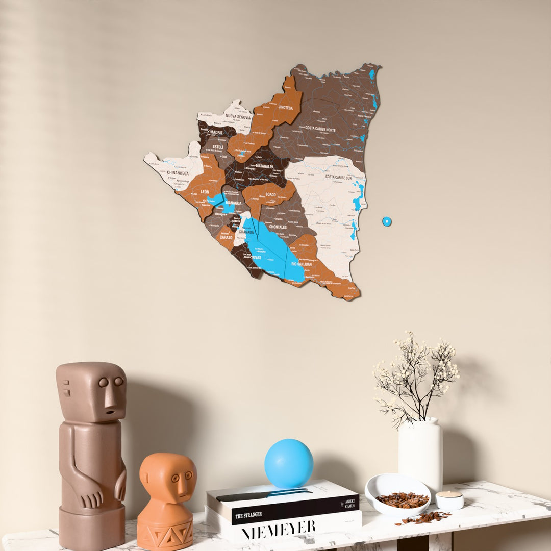 Soil Nicaragua wooden wall map on a beige wall above a console with figurines