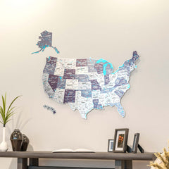 Nimbus metal USA wall map in gray and mauve with state names, above a dark console with framed photos