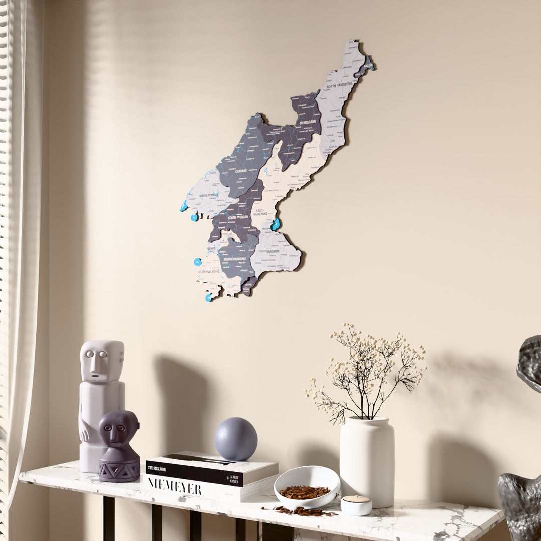 Nimbus North Korea wooden wall map beside a sheer curtain, angled view