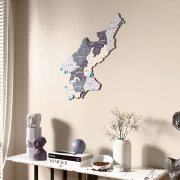 Nimbus North Korea wooden wall map beside a sheer curtain, angled view