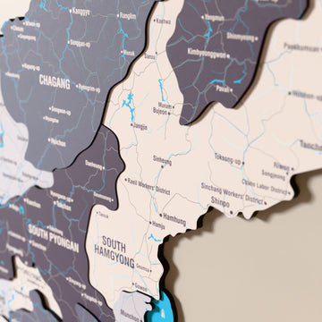 Close-up of the Nimbus North Korea wooden wall map with layered regions and printed names