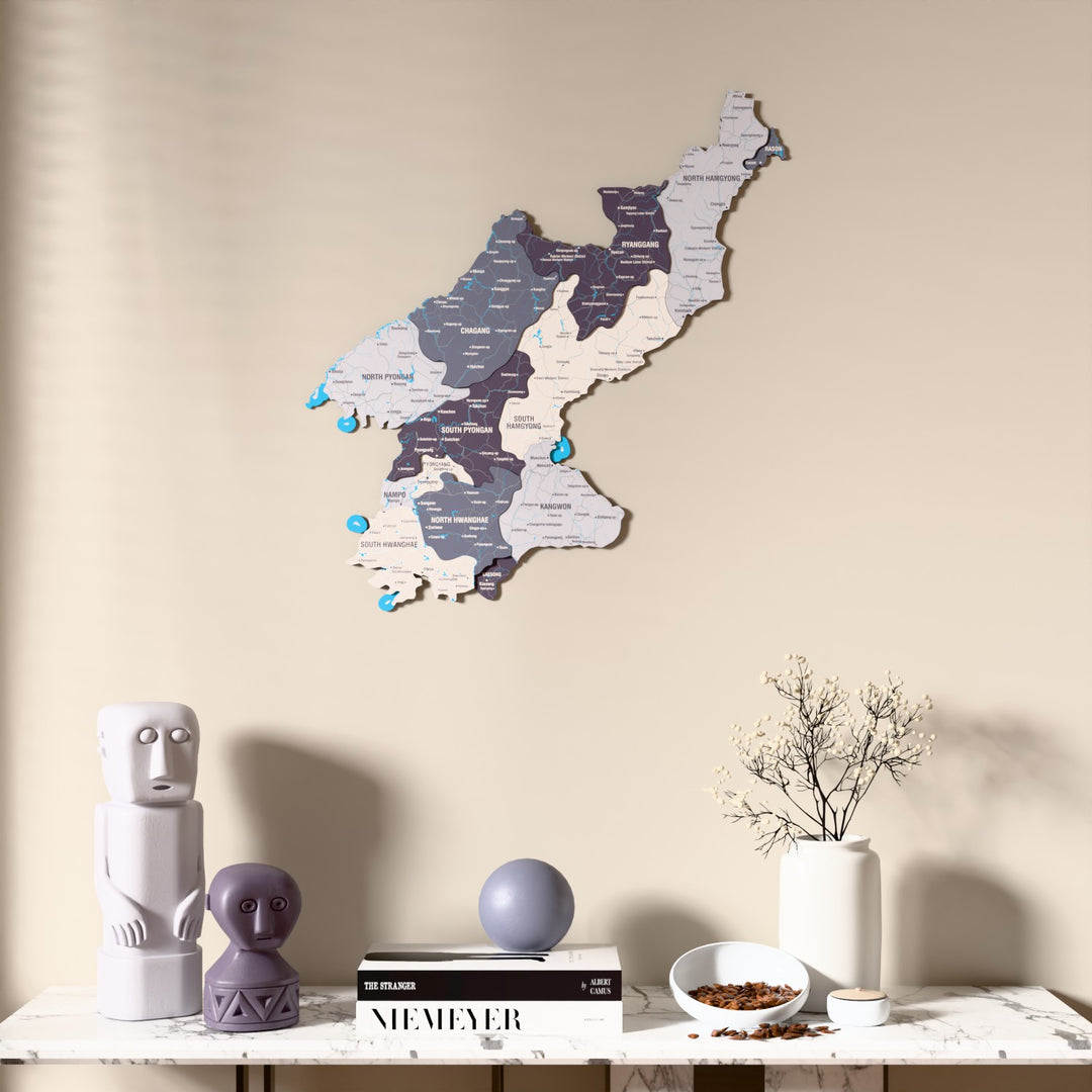 Nimbus North Korea wooden wall map above a marble console, front view