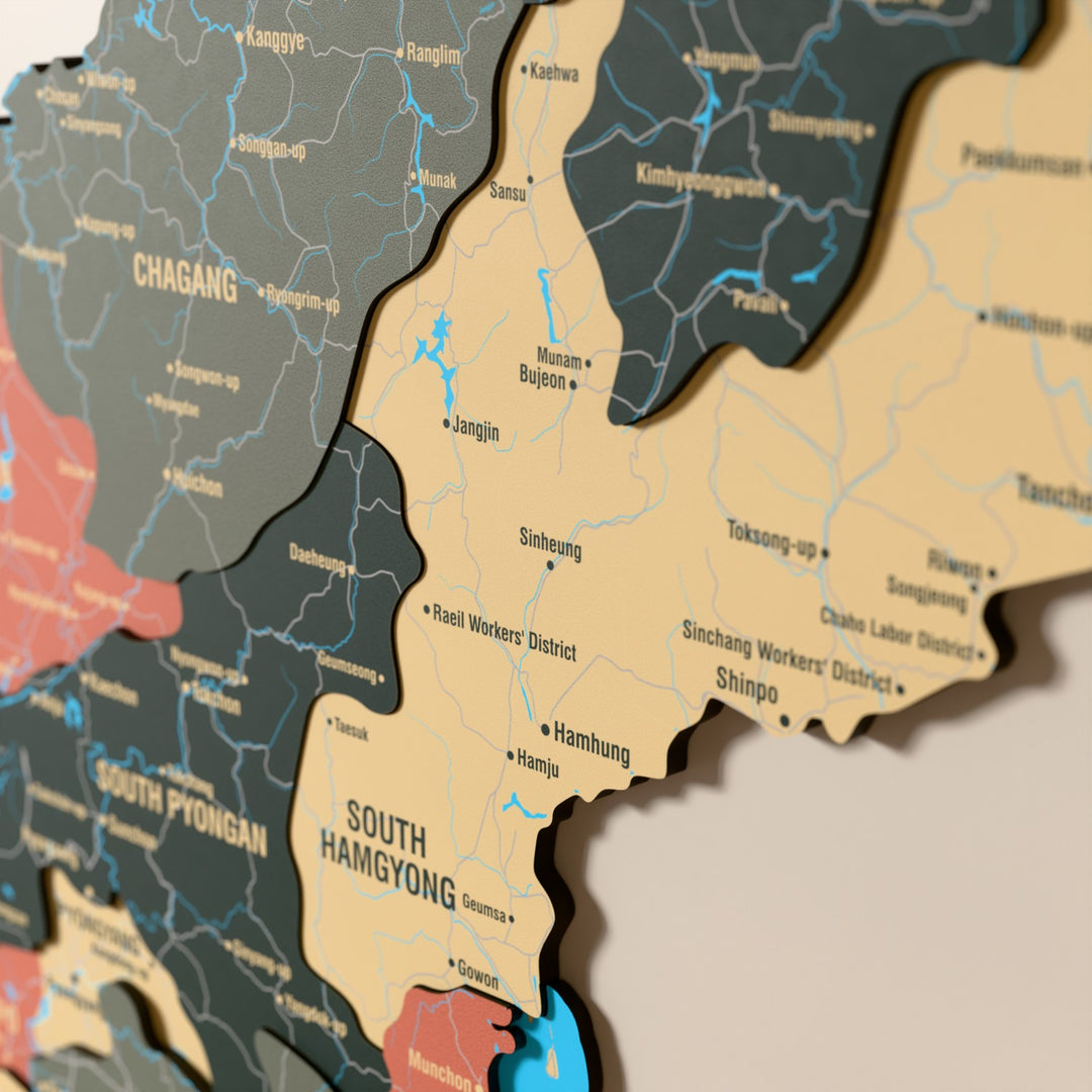 Close-up of the Sage North Korea wooden wall map with layered regions and printed names