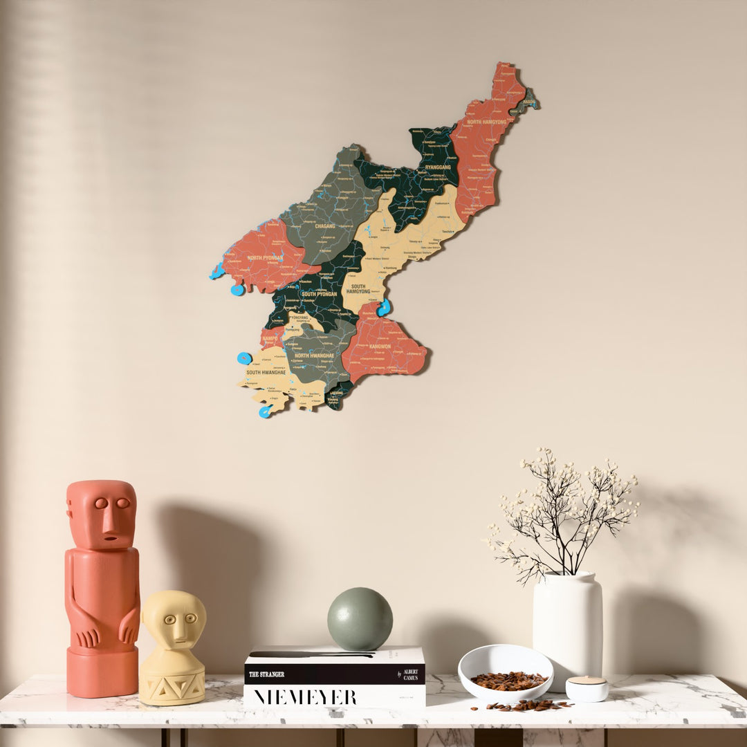 Sage North Korea wooden wall map above a marble console, front view