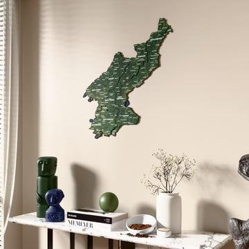 Satellite North Korea wooden wall map beside a sheer curtain, angled view