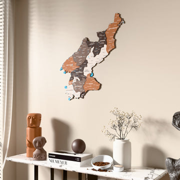 Soil North Korea wooden wall map beside a sheer curtain, angled view