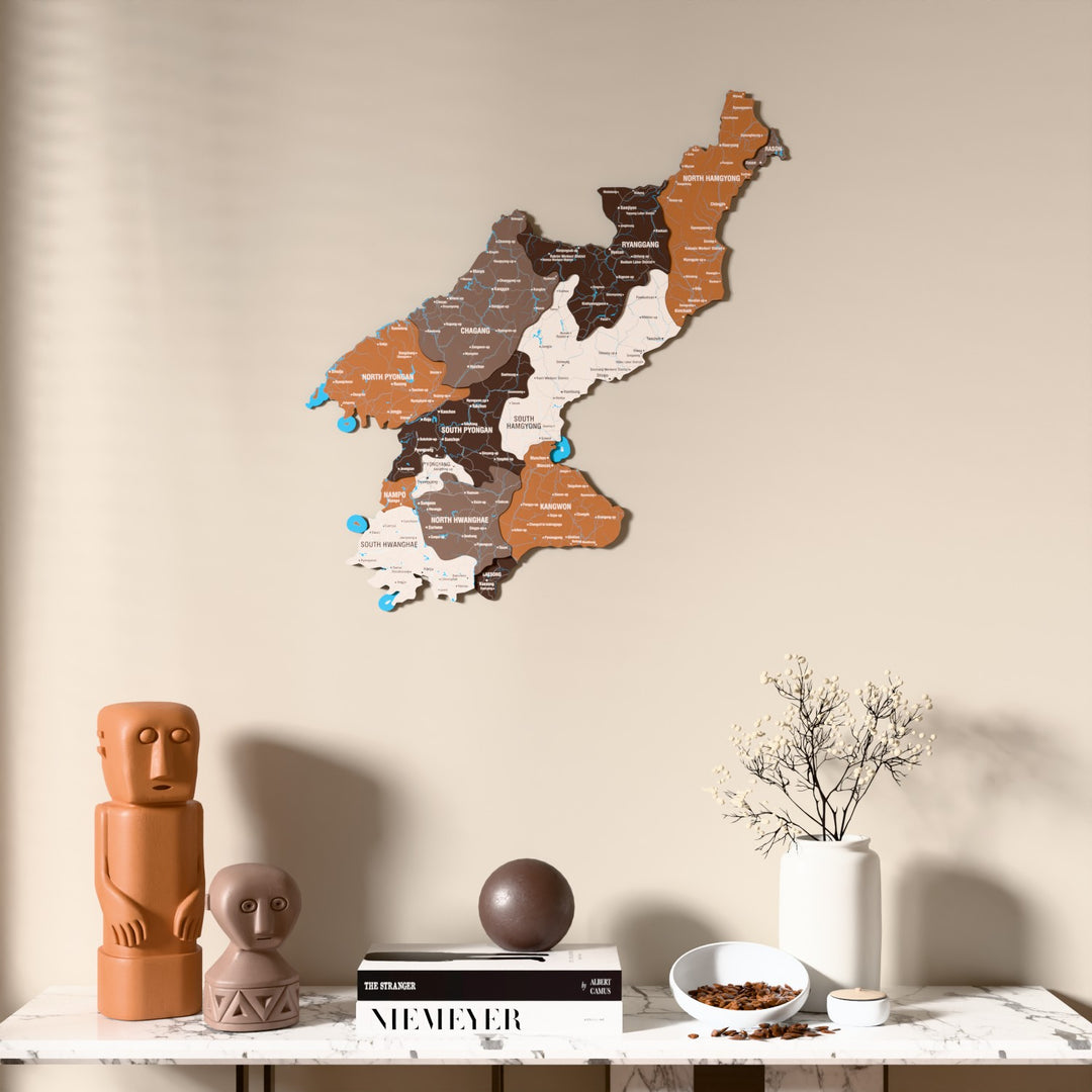 Soil North Korea wooden wall map above a marble console, front view