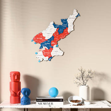 Flag colored North Korea wooden wall map above a marble console, front view