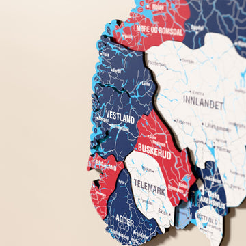 Close-up of the Flag colored Norway wooden wall map with layered regions and printed names