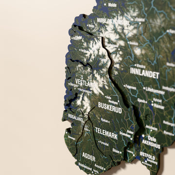 Close-up of the Satellite Norway wooden wall map with layered regions and printed names