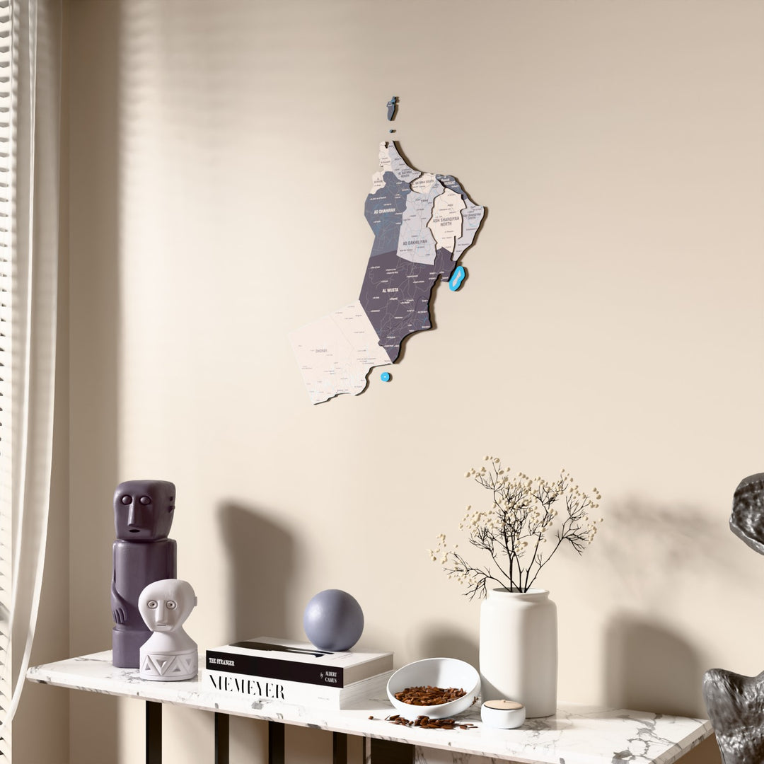 Nimbus Oman wooden wall map beside a sheer curtain, angled view
