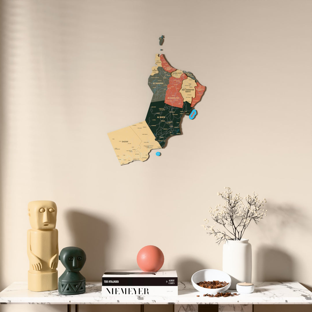 Sage Oman wooden wall map above a marble console, front view
