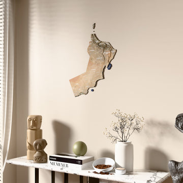 Satellite Oman wooden wall map beside a sheer curtain, angled view