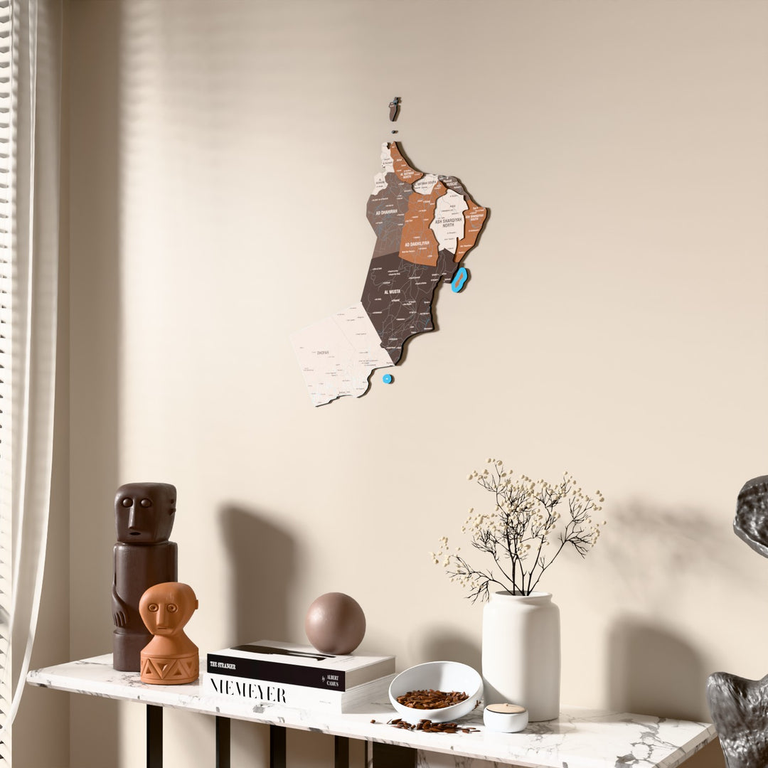 Soil Oman wooden wall map beside a sheer curtain, angled view