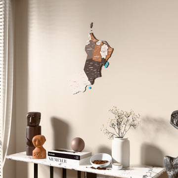 Soil Oman wooden wall map beside a sheer curtain, angled view